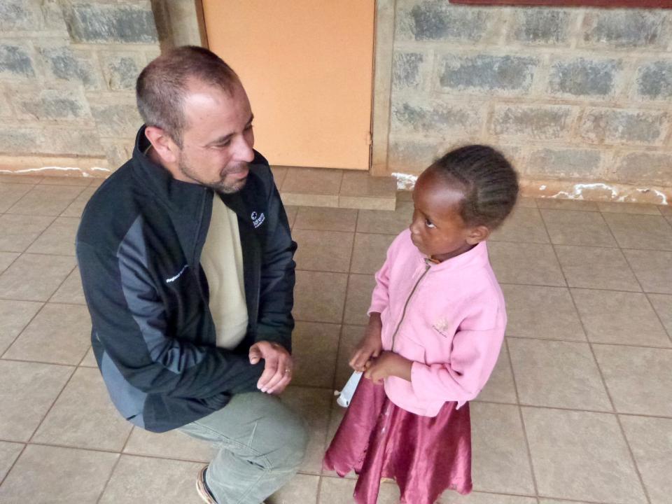 Dr. Ken Shaffer, a Dell Children's cardiologist, meets with a young girl at Ubuntu Life.