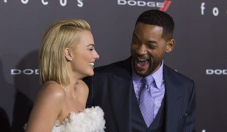 Cast members Will Smith and Margot Robbie pose at the premiere of "Focus" at the TCL Chinese theatre in Hollywood, California February 24, 2015. REUTERS/Mario Anzuoni