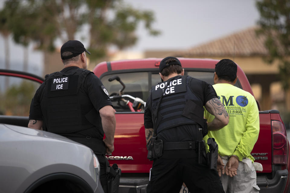 FILE - In this July 8, 2019, file photo, a U.S. Immigration and Customs Enforcement (ICE) officers detain a man during an operation in Escondido, Calif. San Diego County Sheriff Bill Gore says he will comply with U.S. Immigration and Customs Enforcement's request for information on four people with criminal records, becoming the first state or local law enforcement official in the country to so honor such requests among a spate of jurisdictions whose laws sharply restrict cooperation with immigration authorities. (AP Photo/Gregory Bull,File)