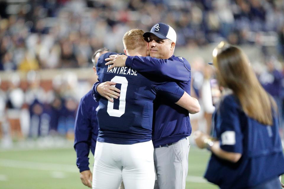 Georgia Southern head coach Clay Helton hugs senior quarterback Kyle Vantrease before the Nov. 26, 2022 game against Appalachian State.