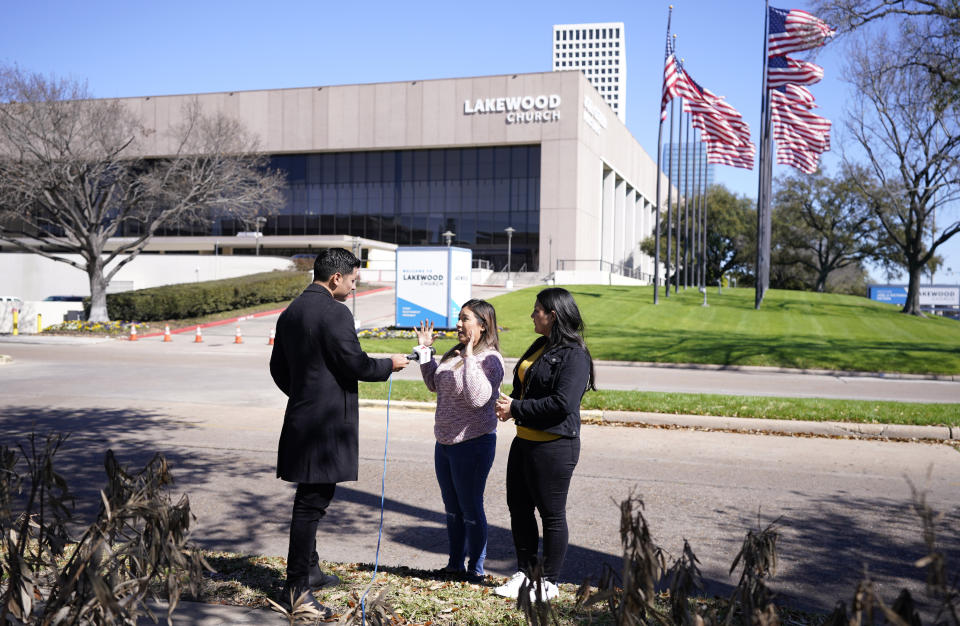 Andrea Espinoza, center, and Nicole Guevara are interviewed by Telemundo reporter Mitchell Zavallos on Monday, Feb. 12, 2024, in Houston, about their experiences during the shooting inside Lakewood Church in Houston. A shooting at the church in left a woman dead and a child critically wounded. (Karen Warren/Houston Chronicle via AP)