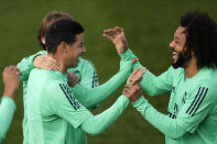 Ream Madrid's James Rodriguez, left, and Marcelo joke during a training session at the team's Valdebebas training ground in Madrid, Spain, Tuesday, Feb. 25, 2020. Real Madrid will play against Manchester City in a Champions League soccer match on Wednesday. (AP Photo/Manu Fernandez)