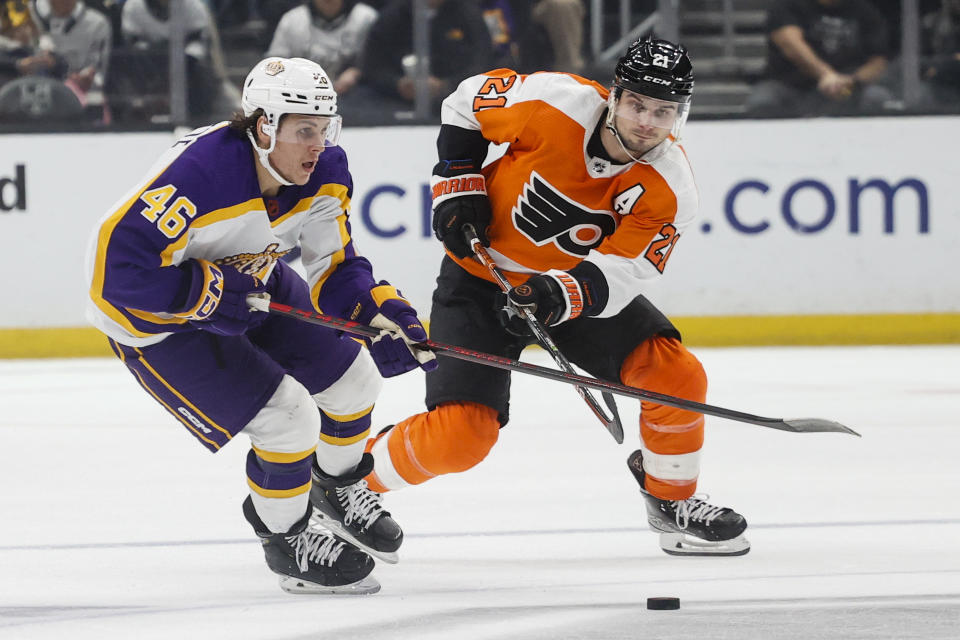 Los Angeles Kings forward Blake Lizotte, right, and Philadelphia Flyers forward Scott Laughton vie for the puck during the second period of an NHL hockey game Saturday, Dec. 31, 2022, in Los Angeles. (AP Photo/Ringo H.W. Chiu)