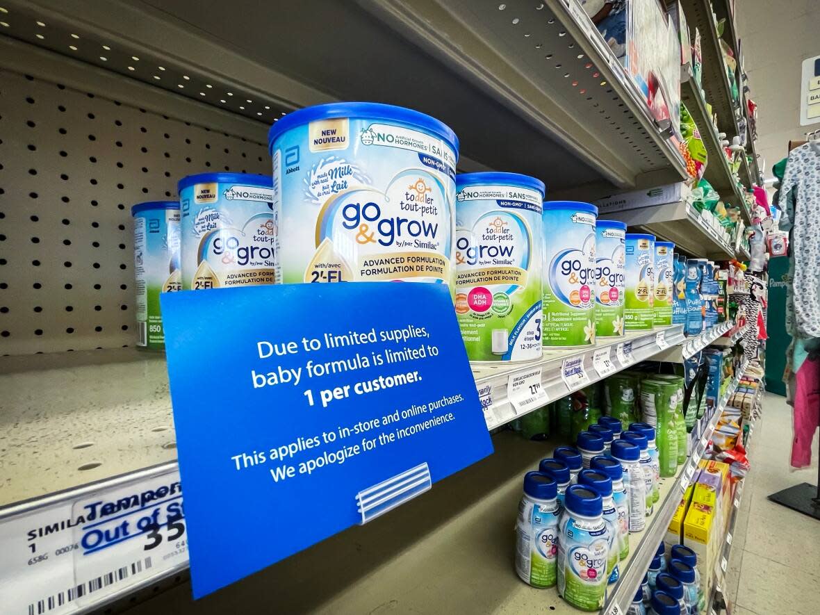 Baby formula is pictured on a shelf — along with a notice on sale limits — at a London Drugs in Surrey, British Columbia. (Ben Nelms/CBC - image credit)