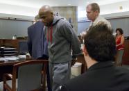 Floyd Mayweather Jr., left, is led away by court marshall Ron Johnson, Friday, June 1, 2012, in Las Vegas, to begin a 90-day jail term for attacking his ex-girlfriend in September 2010 while two of their children watched. The undefeated five-division champion surrendered Friday before the judge who sentenced him in December, and then allowed him to remain free long enough to headline a May 5 fight. (AP Photo/Julie Jacobson)