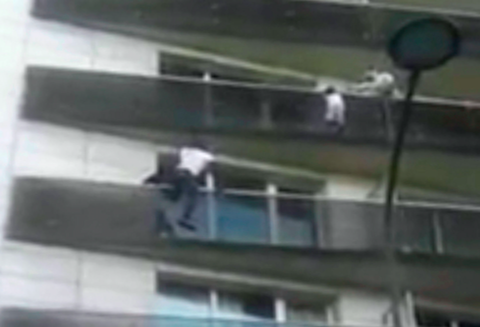 Mamoudou Gassama makes his way up the building to save the boy (Picture: AP)