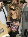 <p>Shakira signs autographs while she arrives at Miami International Airport in June 2005. </p>