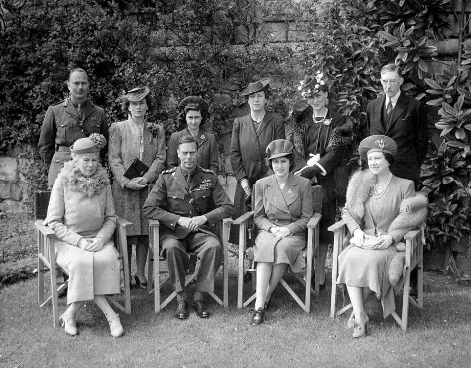 <p>The royals pose for a family portrait outdoors. Queen Mary, King George VI, Princess Elizabeth, and Elizabeth the Queen Mother are seated in the front row, while the Duke and Duchess of Gloucester, Princess Margaret, Princess Mary the Countess of Harewood, the Duchess of Kent, and Henry Lascelles, 6th Earl of Harewood stand behind them.</p>