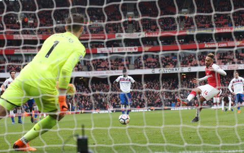 Pierre-Emerick Aubameyang sends Stoke goalkeeper Jack Butland the wrong way - Credit: GETTY IMAGES