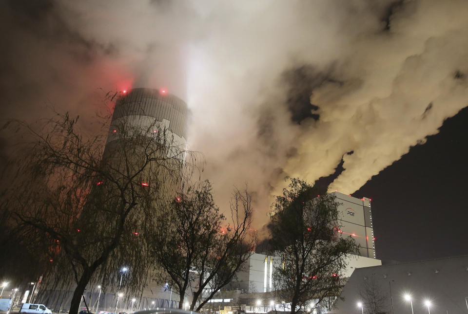 FILE - In this Wednesday, Nov. 28, 2018 file photo, clouds of smoke over Europe's largest lignite power plant in Belchatow, central Poland. Energy experts were working to restore full operations at Poland’s biggest power plant, the lignite-fueled Belchatow, after an energy network failure switched off 10 of the plant’s 11 units. Poland needed energy imports from Germany, Sweden, the Czech Republic and Slovakia to fill in for the suddenly missing power. (AP Photo/Czarek Sokolowski, File)