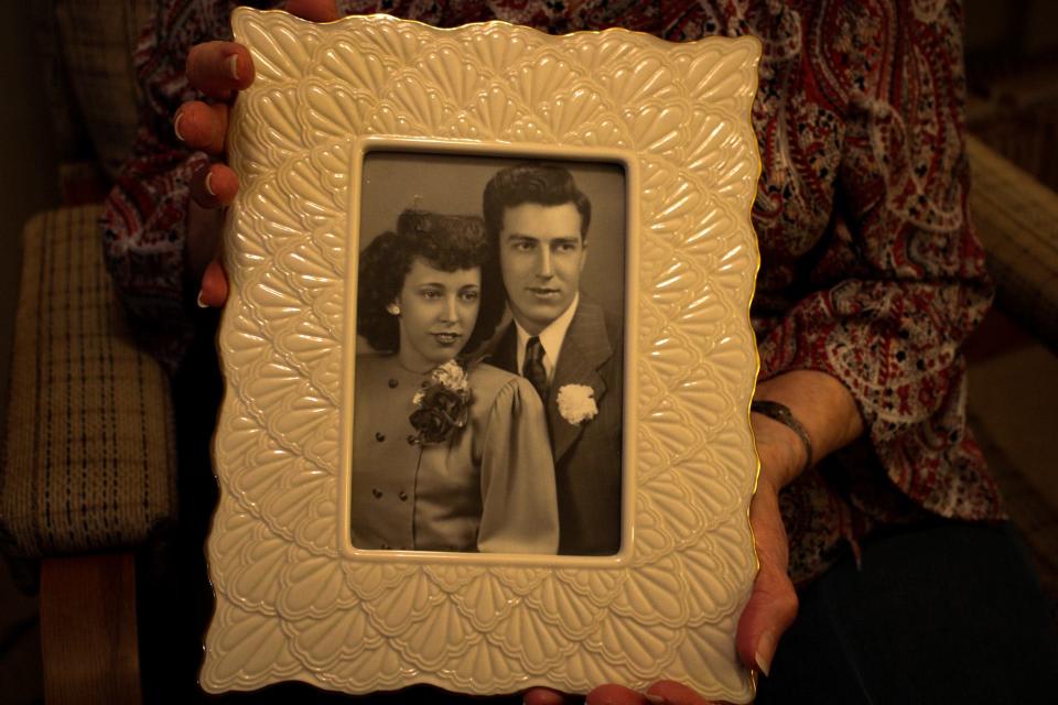 Velma Ames holds her wedding photo with Marlin Ames from 1948.