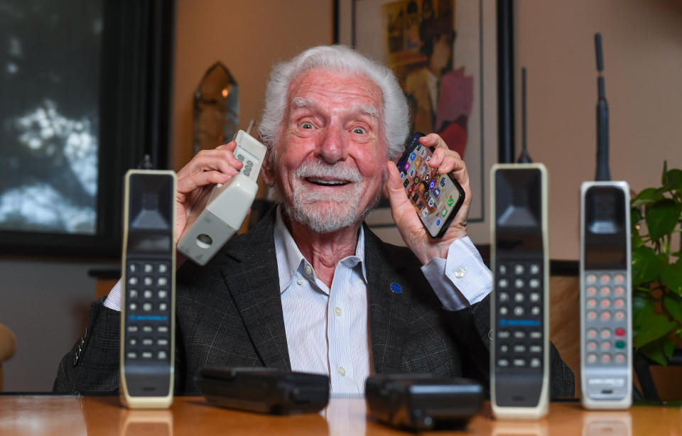 Engineer Martin Cooper holds in his right hand a contemporary copy of the original cell phone he used to make the first cell phone call on April 3, 1973, in Del Mar, California on March 20, 2023.