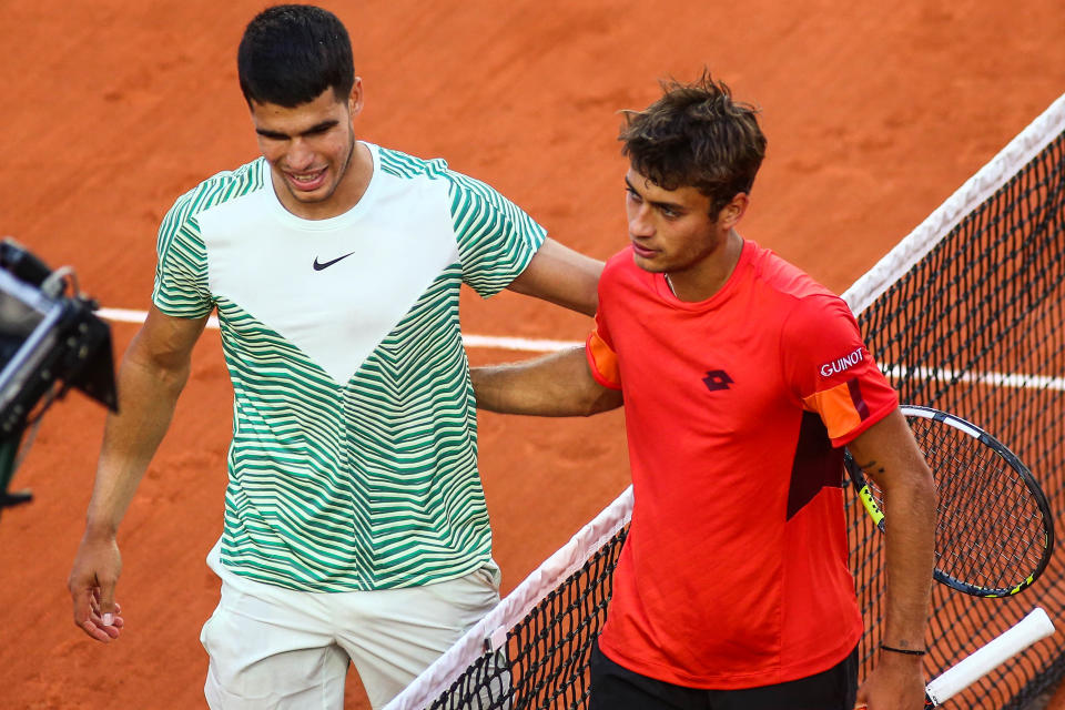 Carlos Alcaraz embraces Flavio Cobolli after their French Open match.