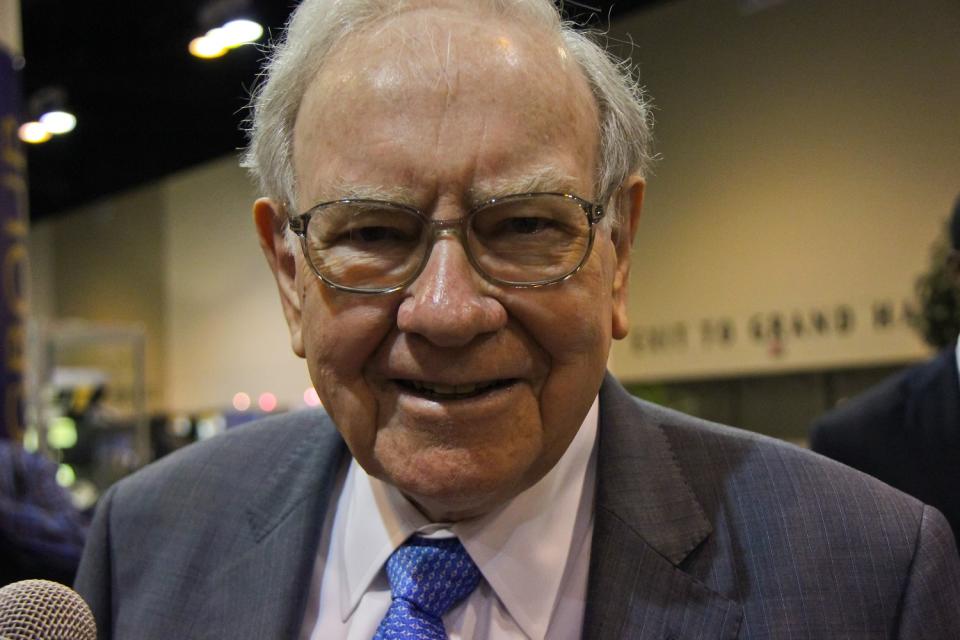 Warren Buffett smiling at the camera.