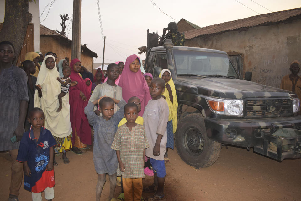 People gather around an area were gunmen kidnapped school children in Chikun, Nigeria, Thursday, March 7, 2024. Gunmen attacked a school in Nigeria's northwest region Thursday morning and abducted at least 287 students, the headteacher told authorities, marking the second mass abduction in the West African nation in less than a week. (AP Photo)