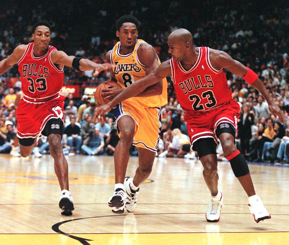 Scottie Pippen (L) and Michael Jordan of the Chicago Bulls try to stop Kobe Bryant of the Los Angeles Lakers (C) (Photo credit should read Vince Bucci/AFP/Getty Images)