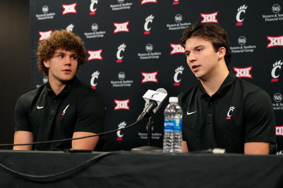 New transfers, tight end Joe Royer (left) and quarterback Brendan Sorsby, take questions during a press conference at the University of Cincinnati’s Fifth Third Arena in Cincinnati on Tuesday, Feb. 13, 2024.