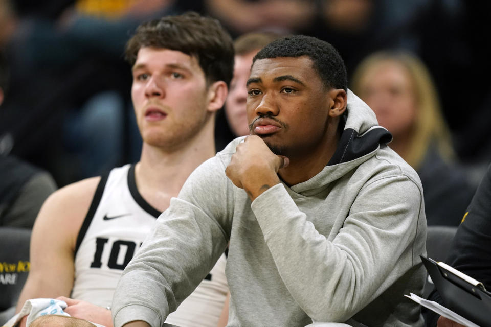 Iowa guard Tony Perkins, right, watches from the bench during the first half of an NCAA college basketball game against Omaha, Monday, Nov. 21, 2022, in Iowa City, Iowa. (AP Photo/Charlie Neibergall)