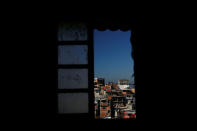 Houses are seen through a window of Tiki hostel in Cantagalo favela, in Rio de Janeiro, Brazil, April 16, 2016. REUTERS/Pilar Olivares