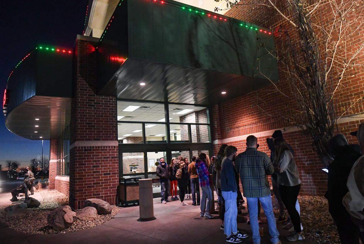 A line starts to form outside Scheels about 20 minutes before the store opens on Black Friday morning, November 25, 2022, in Sioux Falls.