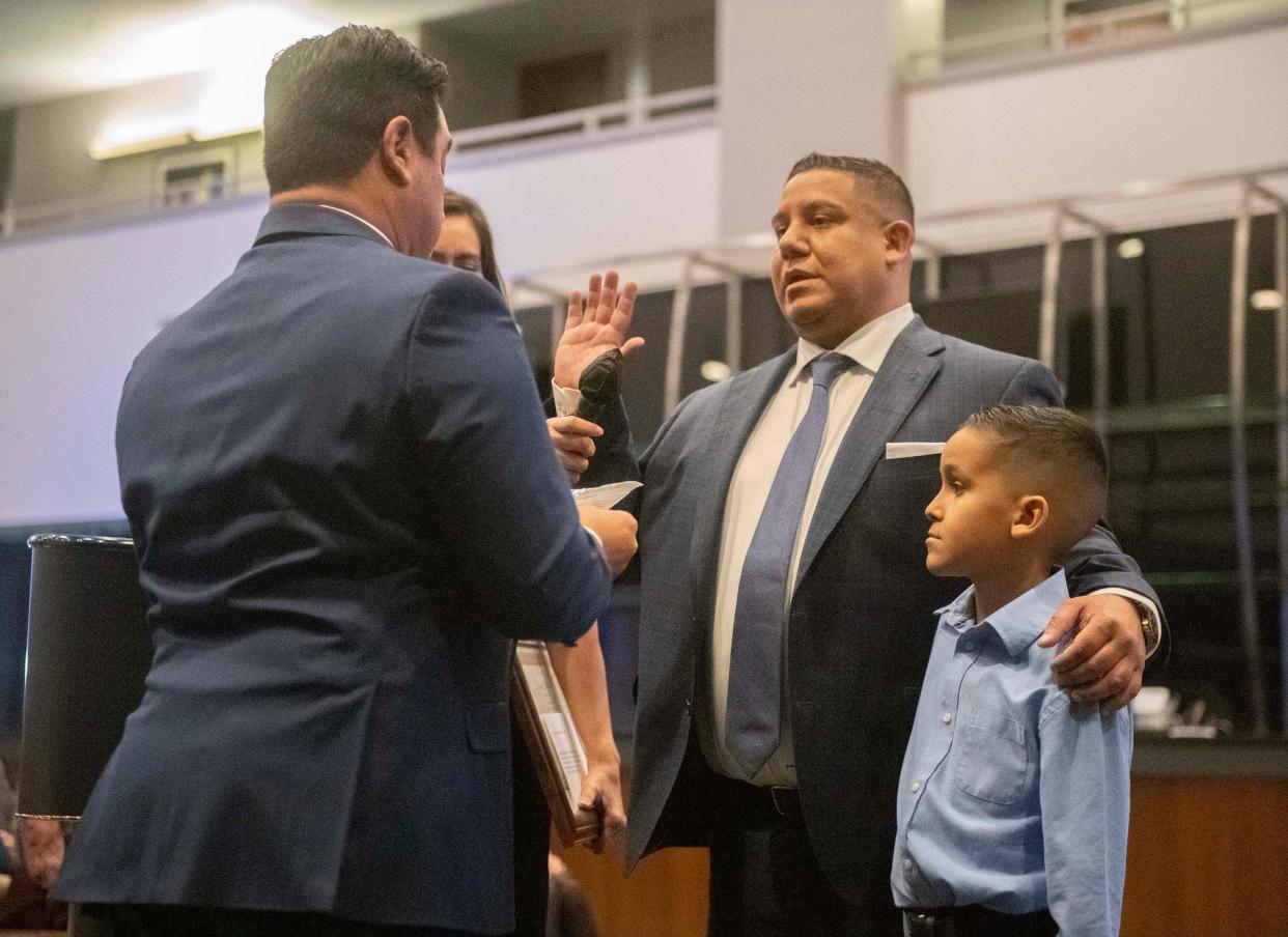 The new Stockton City Council member Brando Villapudua, center, with his son Isaiah at his side, is sworn in by his brother Assemblyman Carlos Villapudua during a ceremony at the Stockton Arena in downtown Stockton on Tuesday, Jan. 10, 2023. 