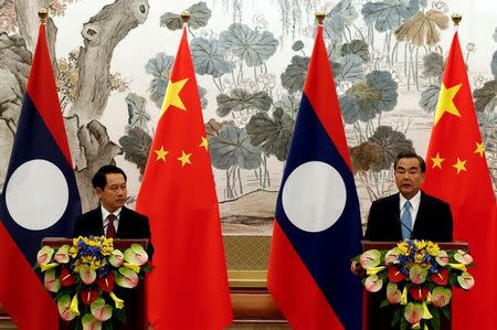 Laos' Foreign Minister Saleumxay Kommasith (L) and his Chinese counterpart Wang Yi hold a news conference after a meeting at the Diaoyutai State Guesthouse in Beijing, China, August 3, 2016. REUTERS/Rolex Dela Pena/Pool/File Photo