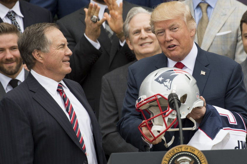 US President Donald Trump holds a football helmet given to him by New England Patriots.