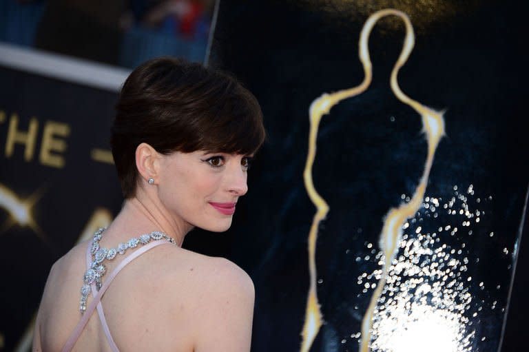 Anne Hathaway arrives on the red carpet for the Oscars on February 24, 2013 in Hollywood, California. Hathaway won for Best Supporting Actress