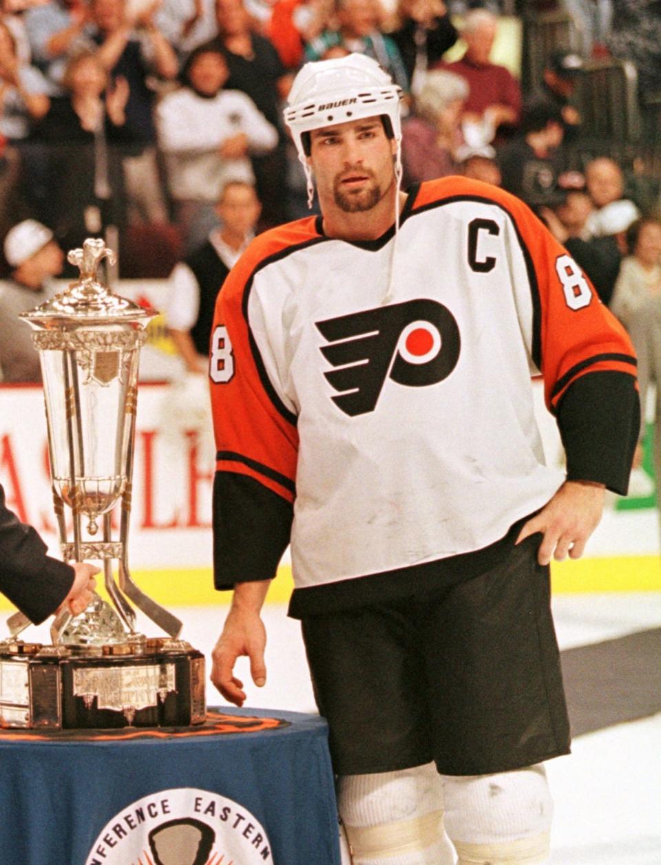 May 25, 1997: Flyers' Eric Lindros stands next to the Prince of Wales Trophy after the Flyers defeated the Rangers to win the Eastern Conference finals in Philadelphia.