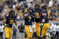 California quarterback Chase Garbers (7) is congratulated by teammates after throwing a touchdown pass against Sacramento State during the first half of an NCAA college football game on Saturday, Sept. 18, 2021, in Berkeley, Calif. (AP Photo/Jed Jacobsohn)