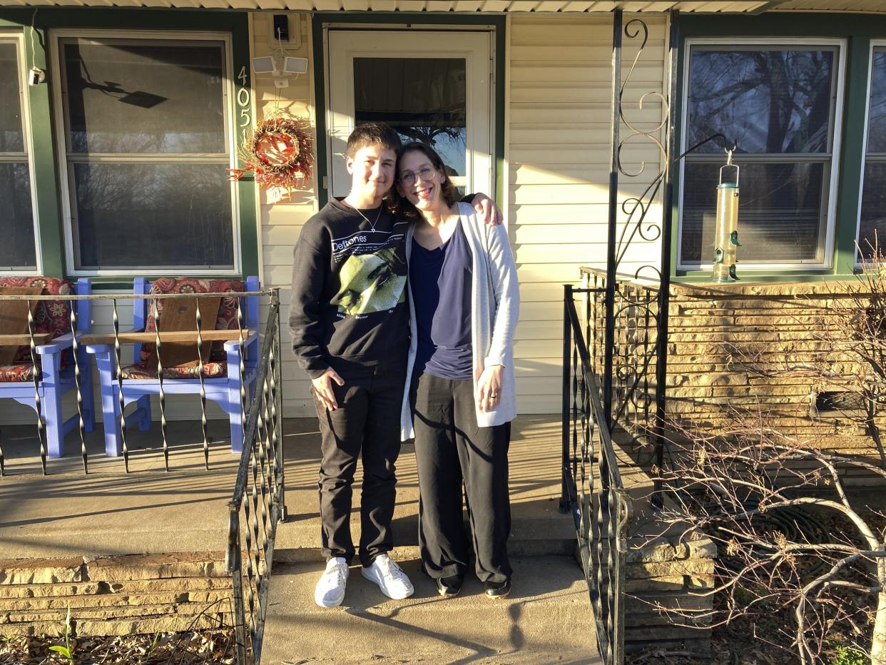 Al Stone-Gebhardt and his mother, Erika Dubose, pose for a photo outside their home on Friday, March 3, 2023, in Tulsa, Okla. As hundreds of bills nationwide take aim at nearly every facet of transgender existence, from health care to athletics to bathroom access, trans kids like Stone-Gebhardt and their families say certain proposals could eliminate one of the last remaining safe havens to explore their identities: K-12 public schools. (AP Photo/Sean Murphy)