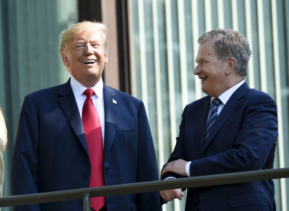 U.S. President Donald Trump, left, and Finnish President Sauli Niinisto talk on the balcony of Niinisto's official residence in Helsinki, Finland, Monday, July 16, 2018 prior to his meeting with Russian President Vladimir Putin in the Finnish capital. (Martti Kainulainen/Lehtikuva via AP)