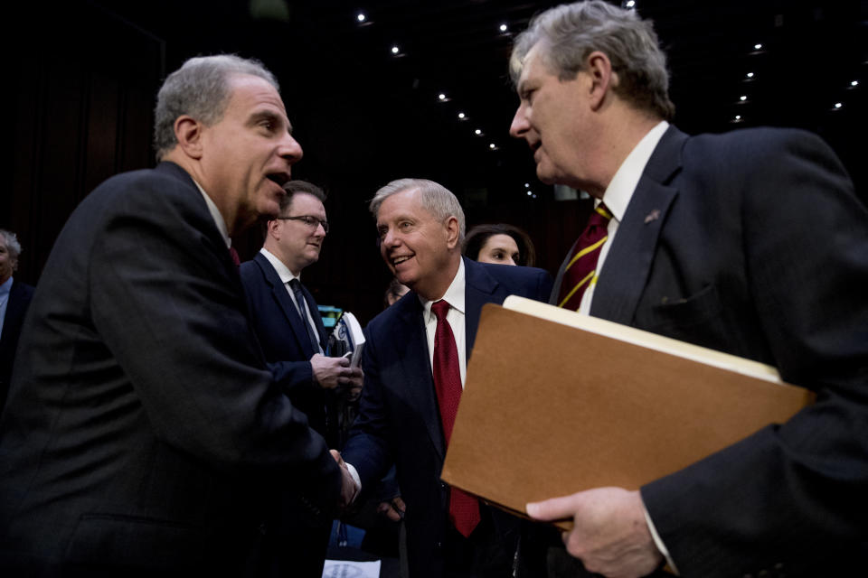 Department of Justice Inspector General Michael Horowitz, left, speaks with Chairman Lindsey Graham, R-S.C., center, and Sen. John Kennedy, R-La., right, after testifying at a Senate Judiciary Committee hearing on the Inspector General's report on alleged abuses of the Foreign Intelligence Surveillance Act, Wednesday, Dec. 11, 2019, on Capitol Hill in Washington. (AP Photo/Andrew Harnik)