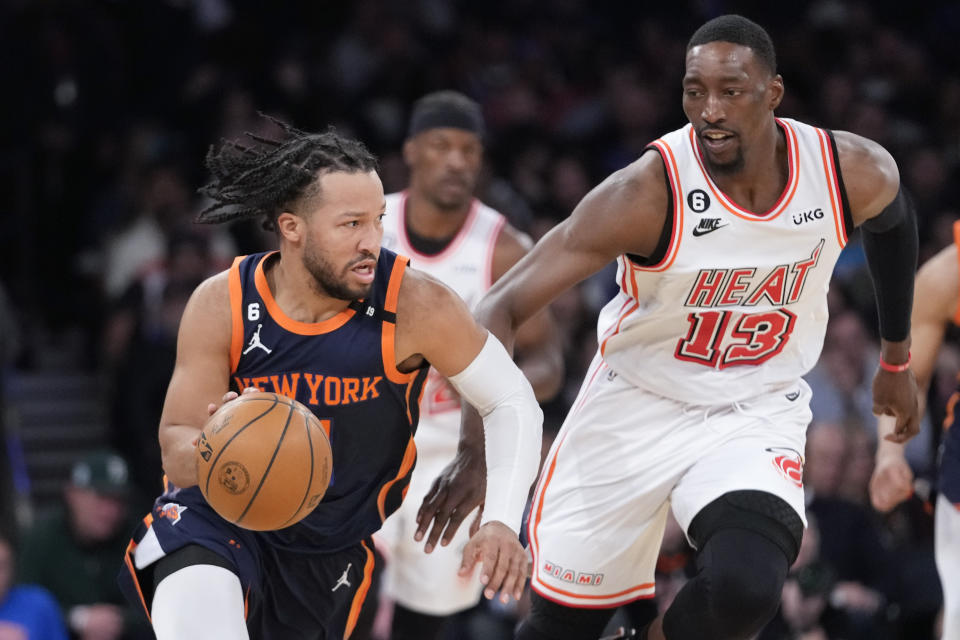 New York Knicks guard Jalen Brunson drives against Miami Heat center Bam Adebayo (13) in the second half of an NBA basketball game, Wednesday, March 29, 2023, at Madison Square Garden in New York. (AP Photo/Mary Altaffer)