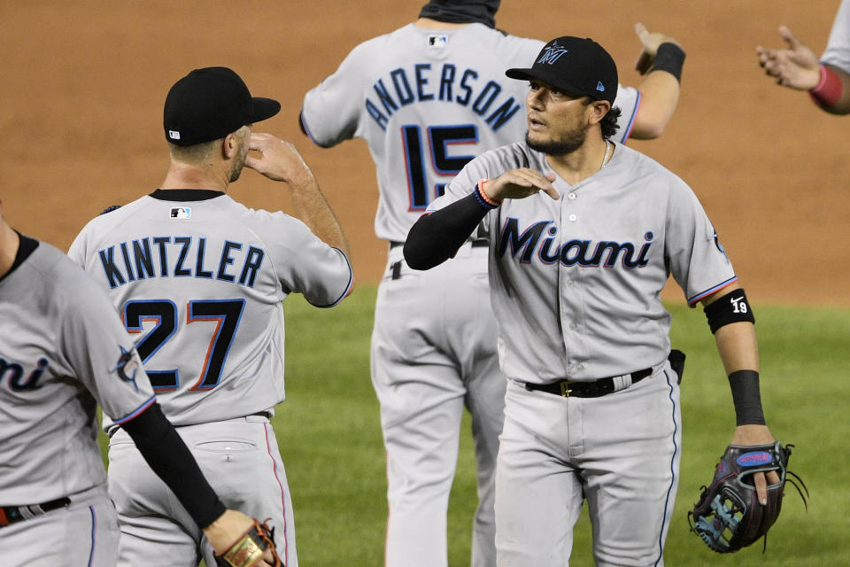 Miami Marlins' Miguel Rojas, right, and Brandon Kintzler (27) celebrate after a baseball game against the Washington Nationals, Friday, Aug. 21, 2020, in Washington. The Marlins won 3-2. (AP Photo/Nick Wass)
