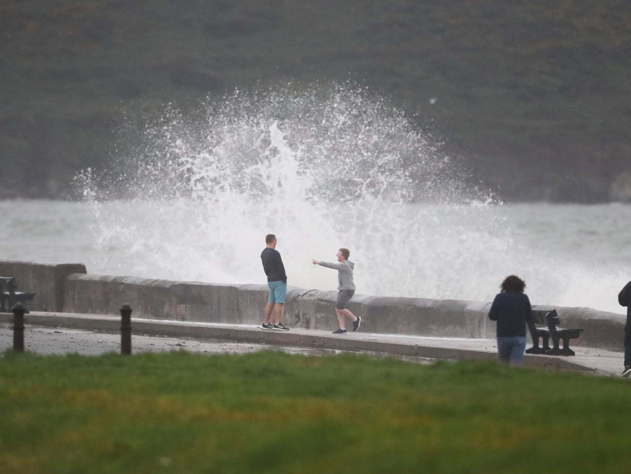 People get hit by a waves crashing on the Front Strand in Youghal, Co. Cork: PA