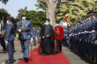 Iran's President Ebrahim Raisi, center, inspects the honor guard after arriving at State House in Entebbe, Uganda Wednesday, July 12, 2023. Iran's president has begun a rare visit to Africa as the country, which is under heavy U.S. economic sanctions, seeks to deepen partnerships around the world. (AP Photo/Hajarah Nalwadda)
