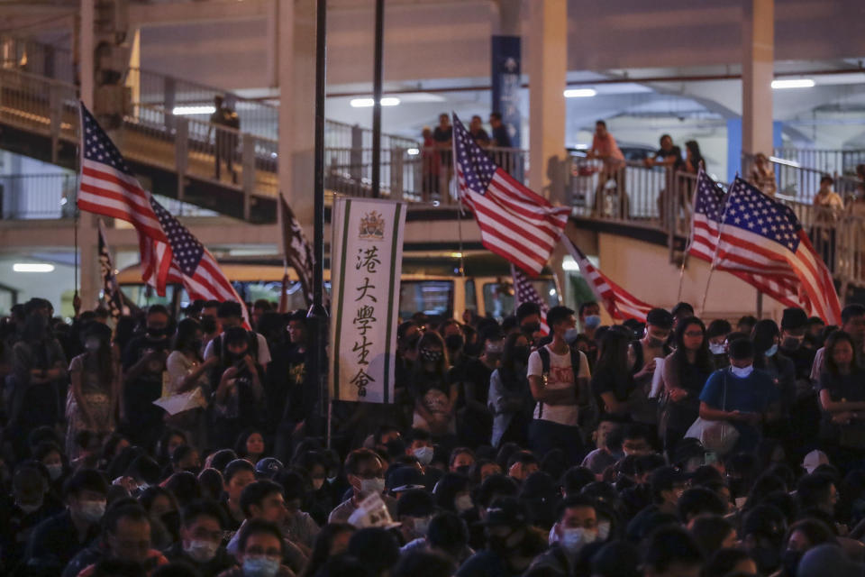 Protesters hold American flags attend a prayer rally at Edinburgh Place in Hong Kong, Saturday, Oct. 19, 2019. Hong Kong pro-democracy protesters are set for another weekend of civil disobedience as they prepare to hold an unauthorized protest march to press their demands. (AP Photo/Mark Schiefelbein)