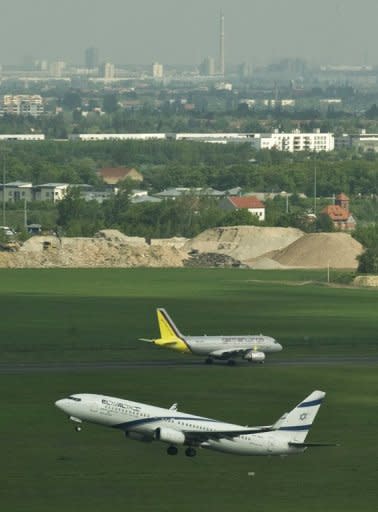 An Israeli El Al aircraft takes off as a German Wings aircraft taxis down the runway at Schoenefeld Airport in Berlin, last month. Airlines flying to, from or within the European Union are required to monitor CO2 emissions for entire journeys and, if necessary, pay for exceeding their carbon allowances