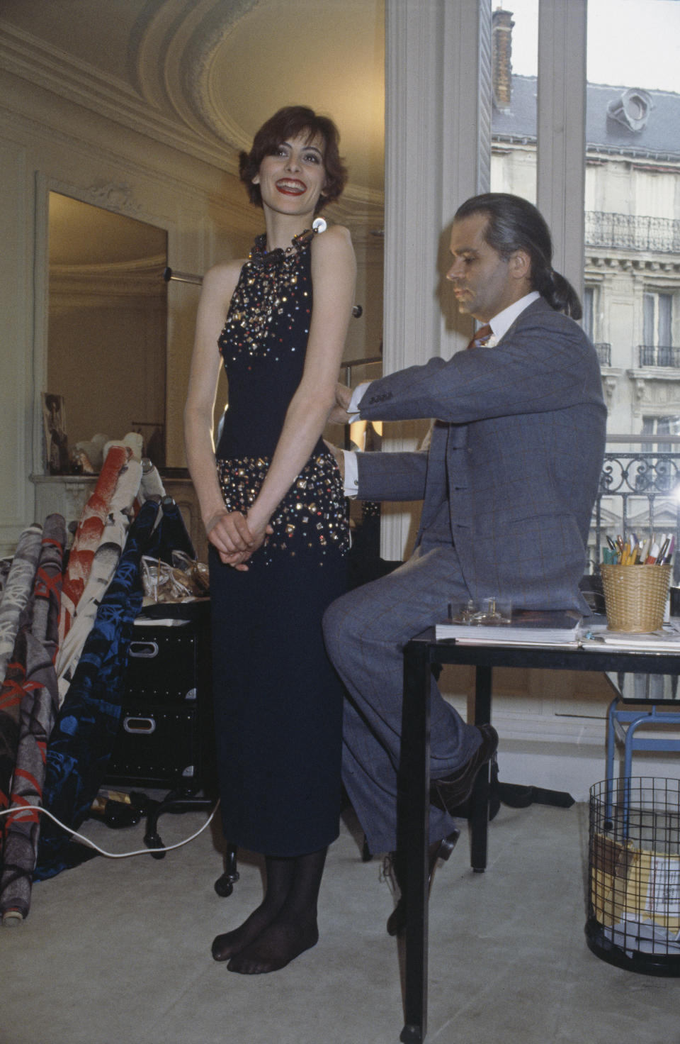 Karl Lagerfeld fits one of his designs on top model In&egrave;s de la Fressange at Chlo&eacute;'s Paris studio in the '80s.