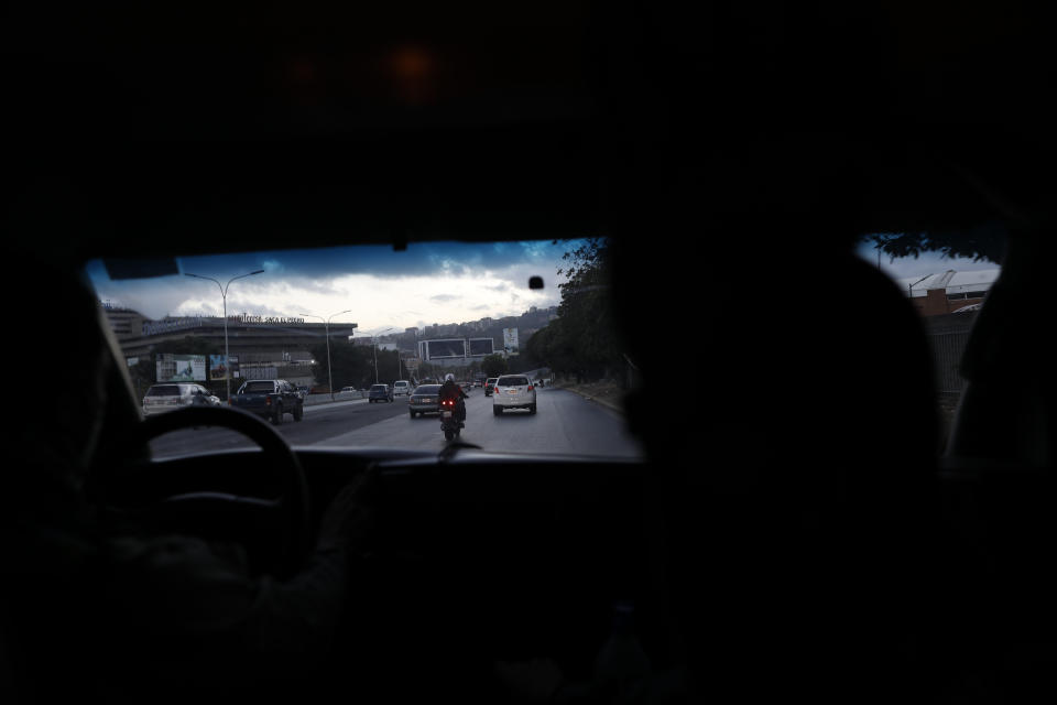 Angels of the Road volunteer paramedics drive their one ambulance on a highway in Caracas, Venezuela, Monday, Feb. 8, 2021. Despite receiving no paychecks, the roughly 40 volunteer paramedics are ready at a moment's notice to jump onto motorcycles and fire up their single ambulance and race into the streets to attend an emergency. (AP Photo/Ariana Cubillos)