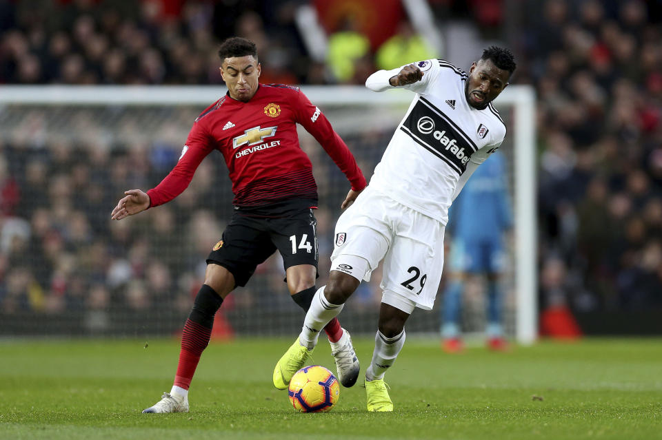 Manchester United's Jesse Lingard, left, and Fulham's Andre-Frank Zambo Anguissa in action during their English Premier League soccer match at Old Trafford, Manchester, England, Saturday, Dec. 8, 2018. (Barrington Coombs/PA via AP)