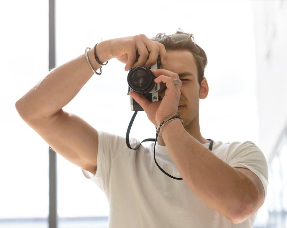 person taking a photo with a film camera