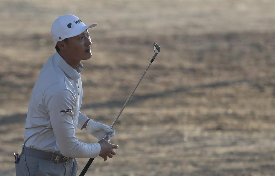 China's Haotong Li follows his ball on the 10th dirt during the second round of the Abu Dhabi Championship golf tournament in Abu Dhabi, United Arab Emirates, Friday, Jan. 17, 2020. (AP Photo/Kamran Jebreili)