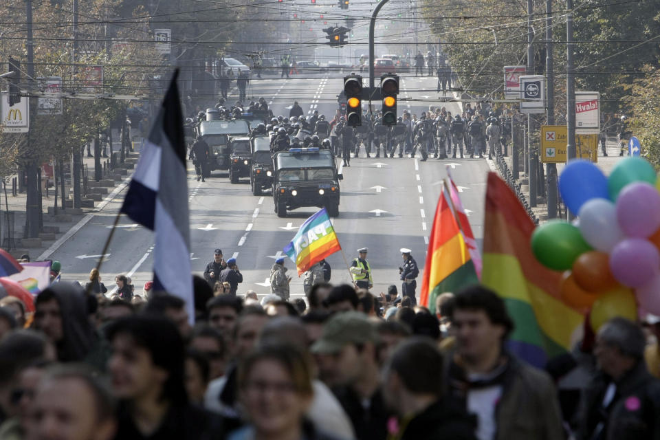 FILE - Serbian riot police gather to protect a gay pride parade as it moves along a street in Belgrade, Serbia, Sunday, Oct. 10, 2010. Organizers of a pan-European LGBTQ events held in Belgrade this week said Friday they will hold a planned Pride march in the Serbian capital despite a police ban and threats from ani-gay groups. Serbia's police have banned the parade that is planned for Saturday, citing a risk of clashes with far-right activists who also said they will gather in protest. Several legal appeals against the ban launched by the Pride week organizers have been rejected by Serbia's authorities. (AP Photo/Darko Vojinovic, File)