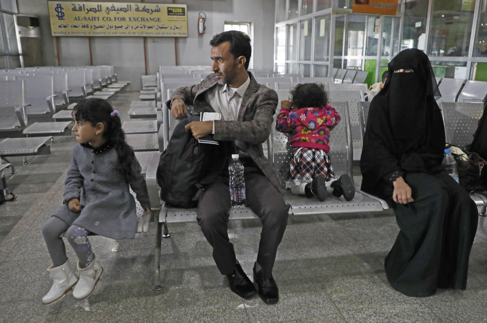 A Yemeni family waits in the departure hall at Sanaa International airport for a U.N. flight, Yemen, Monday, Feb. 3, 2020. The United Nations medical relief flight carrying patients from Yemen's rebel-held capital was the first in over three years. The U.N. said eight patients and their families were flown to Egypt and Jordan to receive “life-saving specialized care not available in Yemen." (AP Photo/Hani Mohammed)