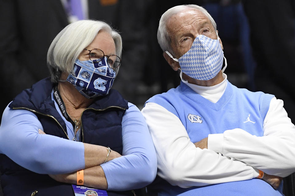 Former North Carolina head coach Roy Williams, right, and wife Wanda Williams watch the first half of an NCAA college basketball game between North Carolina and Purdue, Saturday, Nov. 20, 2021, in Uncasville, Conn. (AP Photo/Jessica Hill)