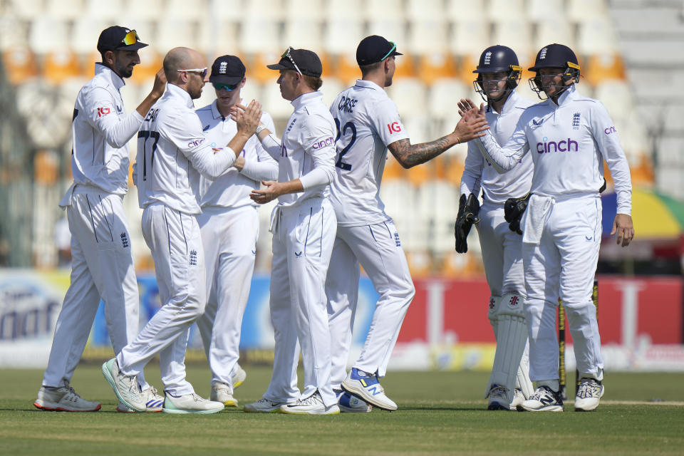 England's Ollie Pope, center, and teammates are congratulated each others after winning the first test cricket match against Pakistan, in Multan, Pakistan, Friday, Oct. 11, 2024. (AP Photo/Anjum Naveed)