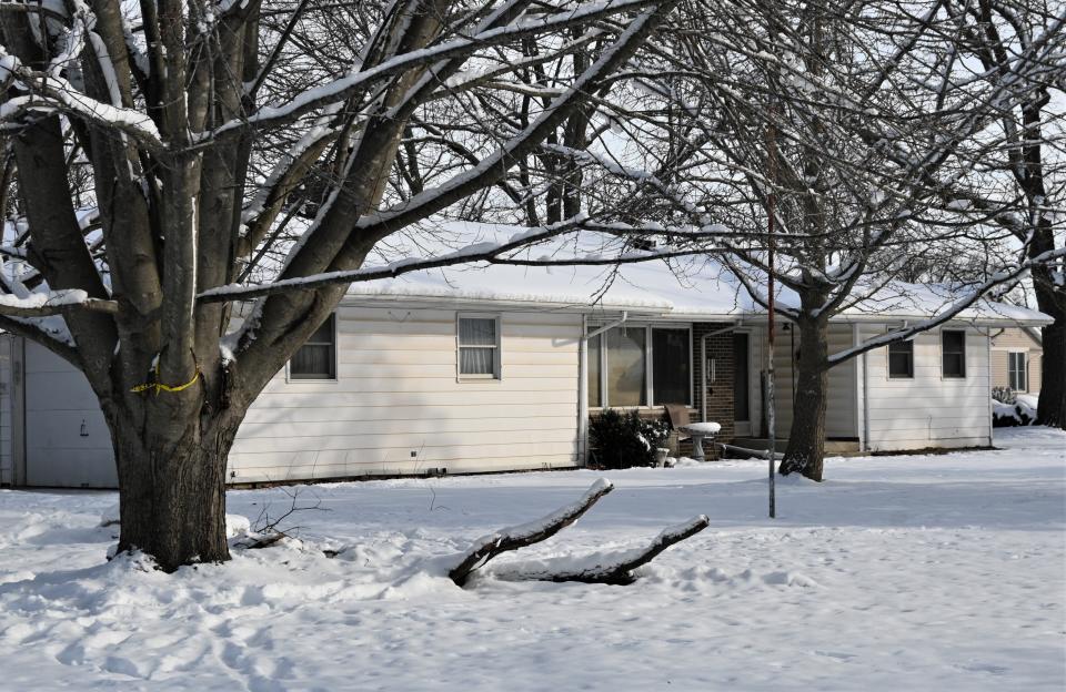 Crime scene tape still hung on the tree outside 505 Pamela Drive Friday morning where Kathleen Rowe was arrested Thursday night.