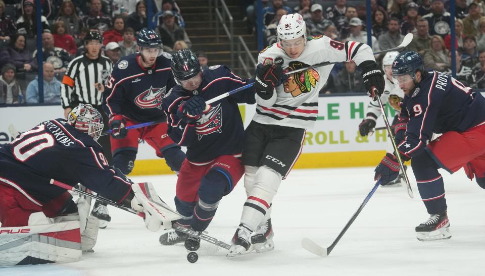 Nov 22, 2023; Columbus, Ohio, USA; Columbus Blue Jackets center Adam Fantilli (11) hooks Chicago Blackhawks center Connor Bedard (98) during the second period of the NHL hockey game at Nationwide Arena in Columbus on November 22, 2023. No penalty was called on this play
